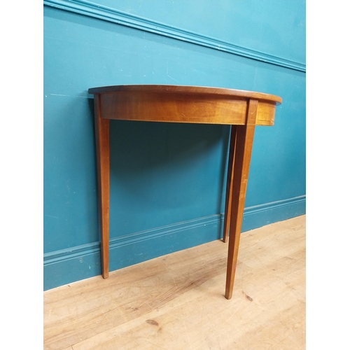 281 - Mahogany and satinwood demi lune table on three tapered feet. {74 cm H x 76 cm W x 41 cm}.