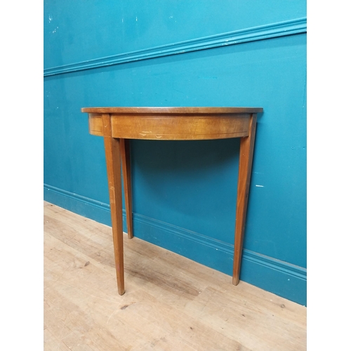 281 - Mahogany and satinwood demi lune table on three tapered feet. {74 cm H x 76 cm W x 41 cm}.