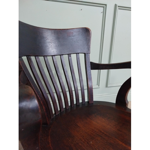 101 - 1950's oak revolving desk chair raised on four shaped outswept feet. {80 cm H x 60 cm W x 60 cm D}.