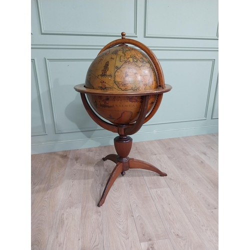 128 - Good quality mahogany world globe drinks cabinet on three outswept feet. {125 cm H x 77 cm Dia.}.