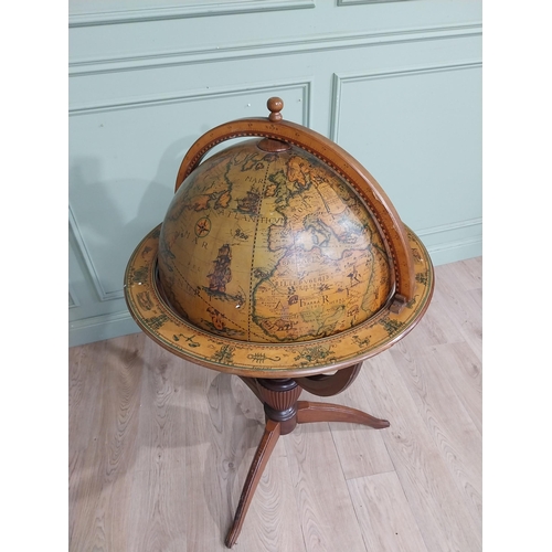 128 - Good quality mahogany world globe drinks cabinet on three outswept feet. {125 cm H x 77 cm Dia.}.