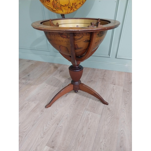 128 - Good quality mahogany world globe drinks cabinet on three outswept feet. {125 cm H x 77 cm Dia.}.