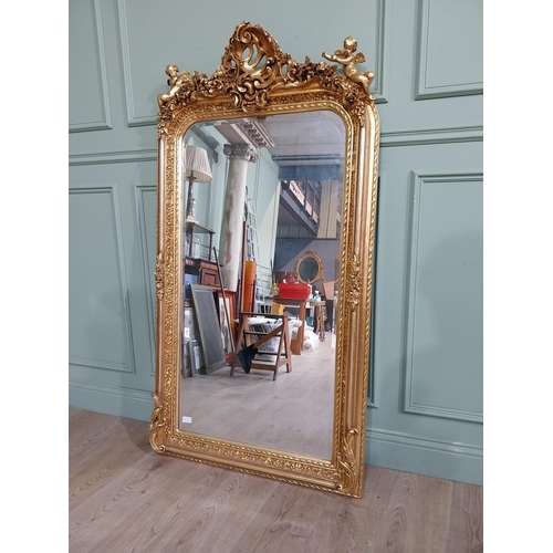 13 - Decorative French gilt mirror surmounted by cherubs and floral decoration in the Victorian style. {1... 