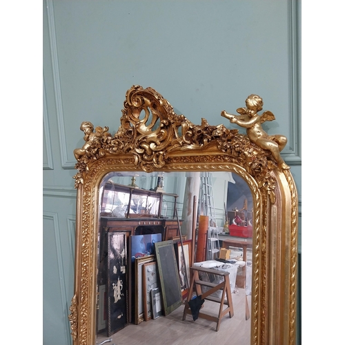 13 - Decorative French gilt mirror surmounted by cherubs and floral decoration in the Victorian style. {1... 