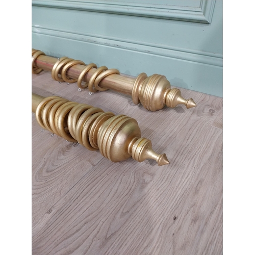 14 - Pair of good quality gilt curtain poles. {240 cm L}.