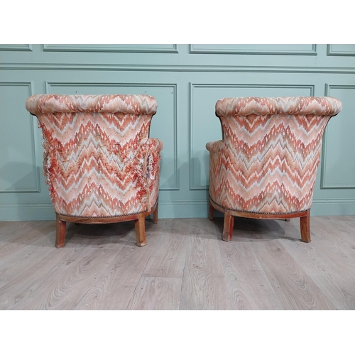 15 - Pair of Edwardian satinwood and upholstered armchairs with stud detail raised on tapered legs. {83 c... 