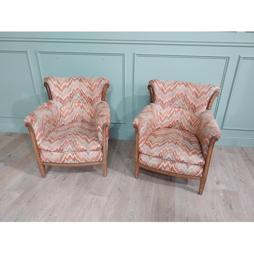 15 - Pair of Edwardian satinwood and upholstered armchairs with stud detail raised on tapered legs. {83 c... 