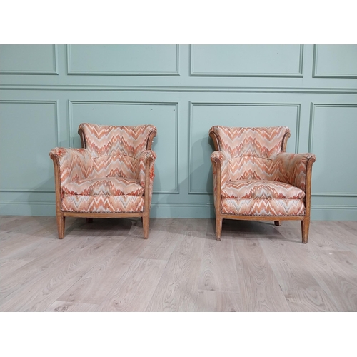 15 - Pair of Edwardian satinwood and upholstered armchairs with stud detail raised on tapered legs. {83 c... 