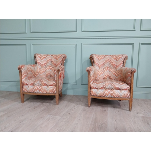 15 - Pair of Edwardian satinwood and upholstered armchairs with stud detail raised on tapered legs. {83 c... 