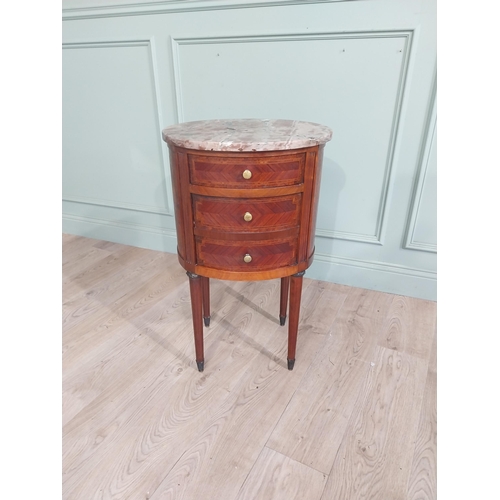 151 - French Edwardian kingwood oval bedside locker with marble top over three short drawers on tapered le... 