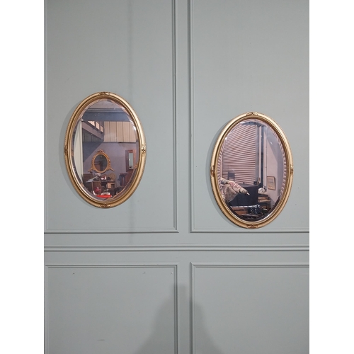 160 - Pair of oval gilt mirrors in the Victorian style with oak leaf decoration. { 86 cm H x 59 cm W}.