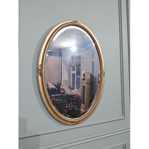 160 - Pair of oval gilt mirrors in the Victorian style with oak leaf decoration. { 86 cm H x 59 cm W}.