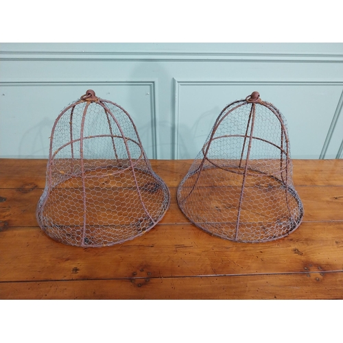 167 - Pair of wrought iron cloches. { 45 cm H x 50 cm Dia.}.