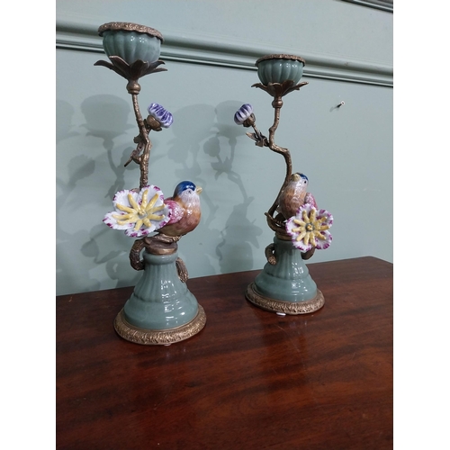 18 - Pair of  ceramic candlesticks decorated with birds and foliage and ormolu mounts. {30 cm H x 15 cm D... 