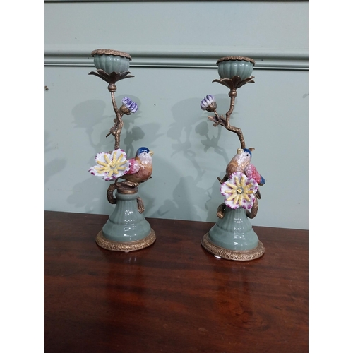 18 - Pair of  ceramic candlesticks decorated with birds and foliage and ormolu mounts. {30 cm H x 15 cm D... 