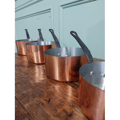 21 - Graduated set of five good quality French copper saucepans with wrought iron handles. {18 cm H x 40 ... 