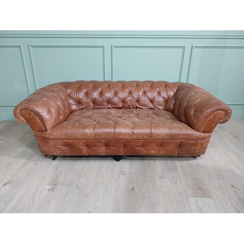 29 - Leather three seater chesterfield sofa. {60 cm H x 193 cm W x 100 cm D}.