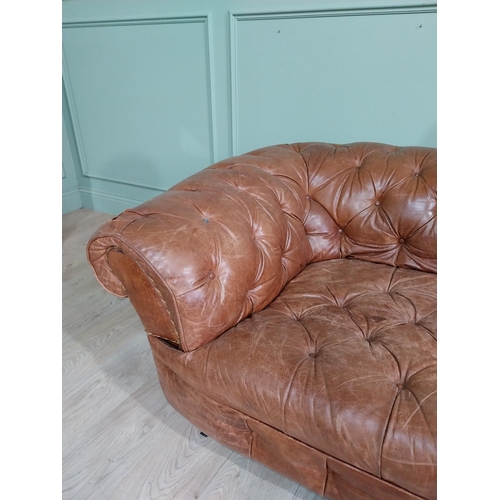 29 - Leather three seater chesterfield sofa. {60 cm H x 193 cm W x 100 cm D}.