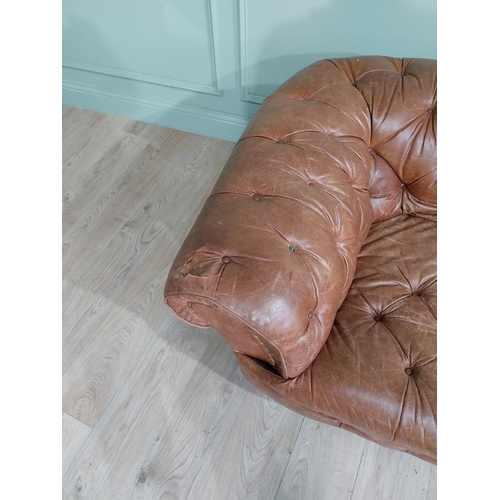 29 - Leather three seater chesterfield sofa. {60 cm H x 193 cm W x 100 cm D}.