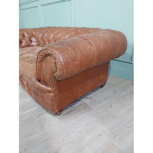 29 - Leather three seater chesterfield sofa. {60 cm H x 193 cm W x 100 cm D}.