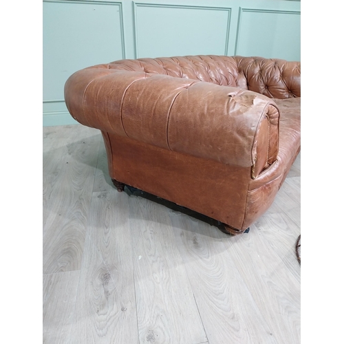 29 - Leather three seater chesterfield sofa. {60 cm H x 193 cm W x 100 cm D}.