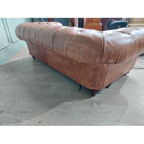 29 - Leather three seater chesterfield sofa. {60 cm H x 193 cm W x 100 cm D}.