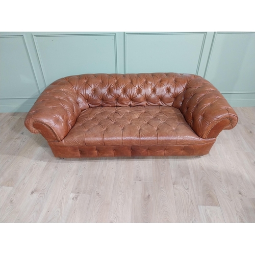 30 - Leather three seater chesterfield sofa. {60 cm H x 193 cm W x 100 cm D}.