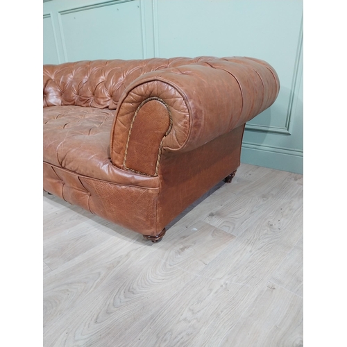 30 - Leather three seater chesterfield sofa. {60 cm H x 193 cm W x 100 cm D}.