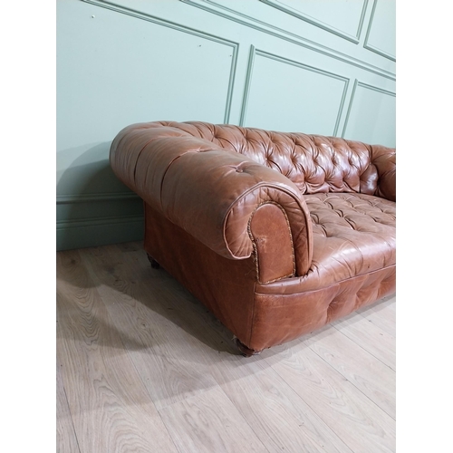 30 - Leather three seater chesterfield sofa. {60 cm H x 193 cm W x 100 cm D}.