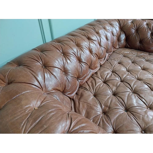 30 - Leather three seater chesterfield sofa. {60 cm H x 193 cm W x 100 cm D}.