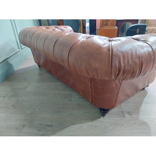 30 - Leather three seater chesterfield sofa. {60 cm H x 193 cm W x 100 cm D}.