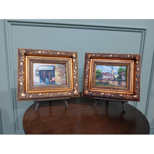 323 - Pair of oleographs mounted on ornate gilt framed oil on easel stands � Village Scene and Cafe Scene.... 