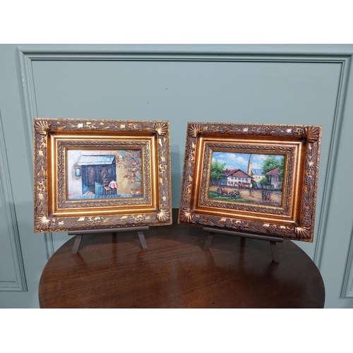 323 - Pair of oleographs mounted on ornate gilt framed oil on easel stands � Village Scene and Cafe Scene.... 