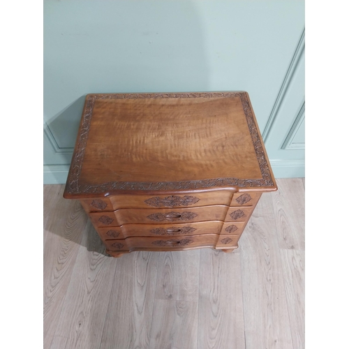 324 - 1950�s camphor wood bank of drawers with fitted interior above three long drawers with leaf decorati... 