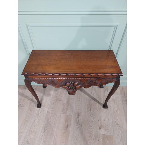 329 - Irish mahogany side table in the Georgian style with carved fruit basket in frieze raised on shaped ... 