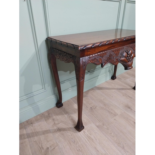 329 - Irish mahogany side table in the Georgian style with carved fruit basket in frieze raised on shaped ... 