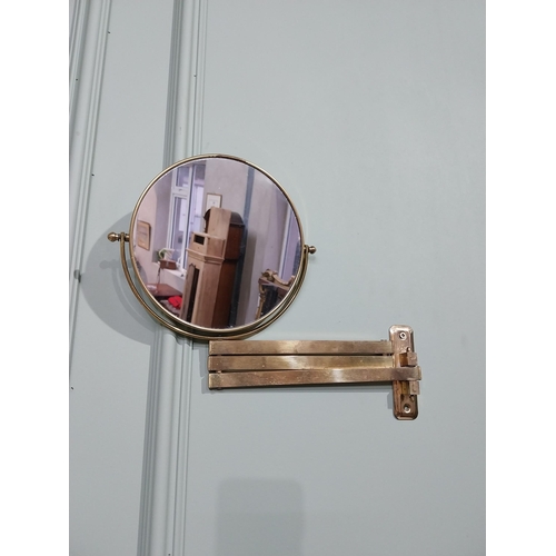 35 - Brass angle poise wall mounted mirror. {26 cm H x 30 cm W x 30 cm D}.