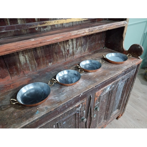 36 - Set of four French copper and brass pans. {5 cm H x 27 cm W x 20 cm D}.