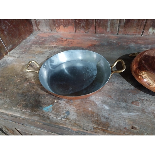 36 - Set of four French copper and brass pans. {5 cm H x 27 cm W x 20 cm D}.