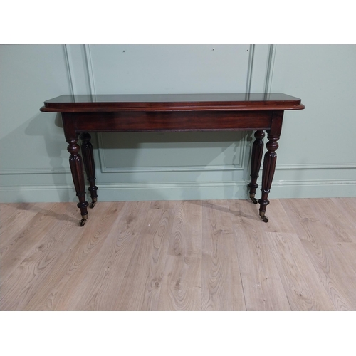 375 - Good quality 19th C. Mahogany side table raised on four turned legs and castors. {77 cm H x 142 cm W... 