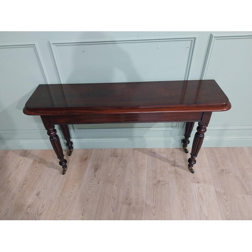 375 - Good quality 19th C. Mahogany side table raised on four turned legs and castors. {77 cm H x 142 cm W... 