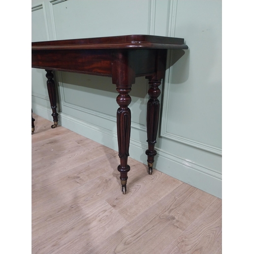 375 - Good quality 19th C. Mahogany side table raised on four turned legs and castors. {77 cm H x 142 cm W... 