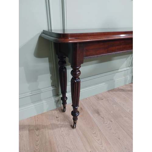 375 - Good quality 19th C. Mahogany side table raised on four turned legs and castors. {77 cm H x 142 cm W... 