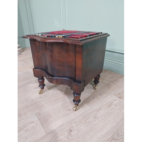 384 - 19th C. Mahogany commode with upholstered seat raised on turned legs and brass castors. {48 cm H x 4... 