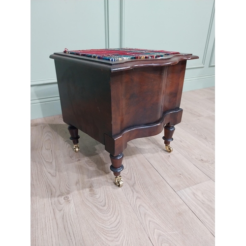 384 - 19th C. Mahogany commode with upholstered seat raised on turned legs and brass castors. {48 cm H x 4... 