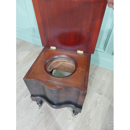 384 - 19th C. Mahogany commode with upholstered seat raised on turned legs and brass castors. {48 cm H x 4... 