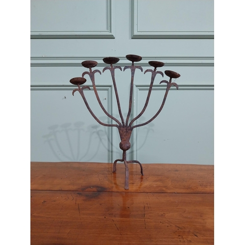 385 - Wrought iron six branch candle stick on three outswept feet. {37 cm H x 32 cm W x 14 cm D}.