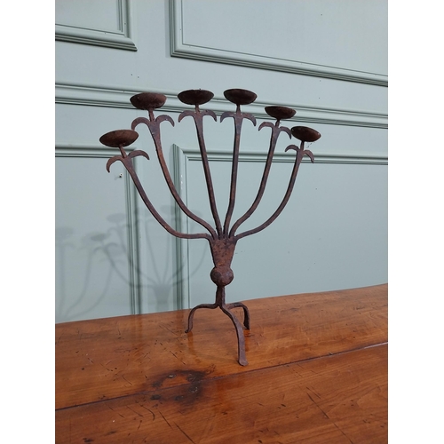 385 - Wrought iron six branch candle stick on three outswept feet. {37 cm H x 32 cm W x 14 cm D}.