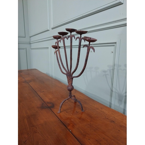 385 - Wrought iron six branch candle stick on three outswept feet. {37 cm H x 32 cm W x 14 cm D}.