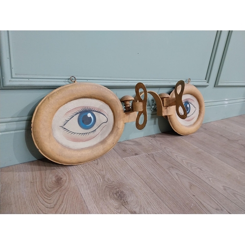 4 - Painted metal optician's sign. {30 cm H x 90 cm W x 15 cm D}.